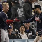 
              Atlanta Braves' Eddie Rosario, right, is congratulated by Atlanta Braves' Joc Pederson after hitting a two-run home run in the ninth inning against the Los Angeles Dodgers in Game 4 of baseball's National League Championship Series Wednesday, Oct. 20, 2021, in Los Angeles. (AP Photo/Marcio Jose Sanchez)
            