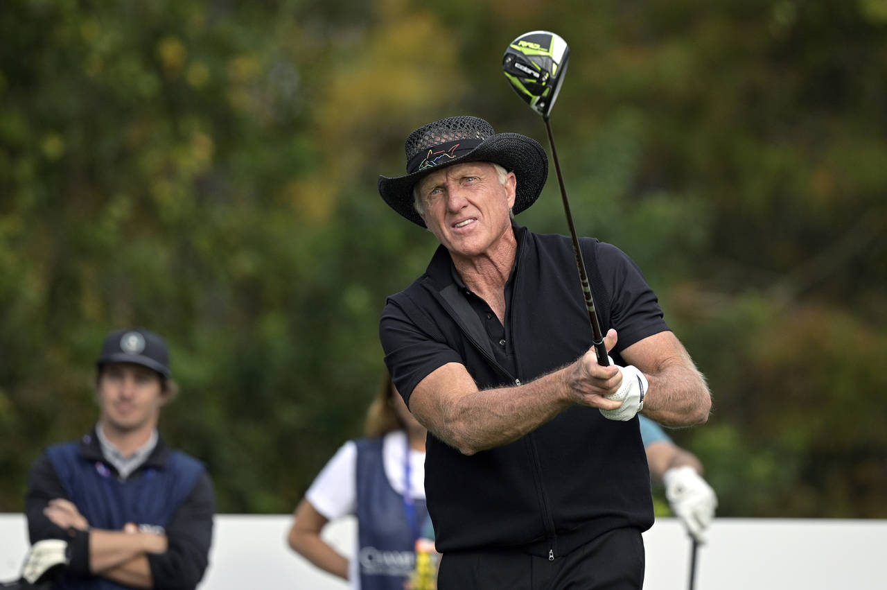 FILE - Greg Norman, of Australia, watches his tee shot on the first hole during the final round of ...