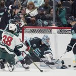 
              Minnesota Wild right wing Ryan Hartman (38) scores a goal past Seattle Kraken goaltender Philipp Grubauer (31) during the first period of an NHL hockey game, Thursday, Oct. 28, 2021, in Seattle. (AP Photo/Ted S. Warren)
            