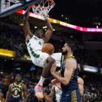 
              Milwaukee Bucks forward Thanasis Antetokounmpo (43) follows though on a dunk over Indiana Pacers center Goga Bitadze (88) during the second half of an NBA basketball game in Indianapolis, Monday, Oct. 25, 2021. The Bucks defeated the Pacers 119-109. (AP Photo/Michael Conroy)
            