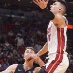 
              Miami Heat guard Tyler Herro (14) drives to the basket over Orlando Magic forward Franz Wagner (22), during the first half of an NBA basketball game, Monday, Oct. 25, 2021, in Miami. (AP Photo/Marta Lavandier)
            