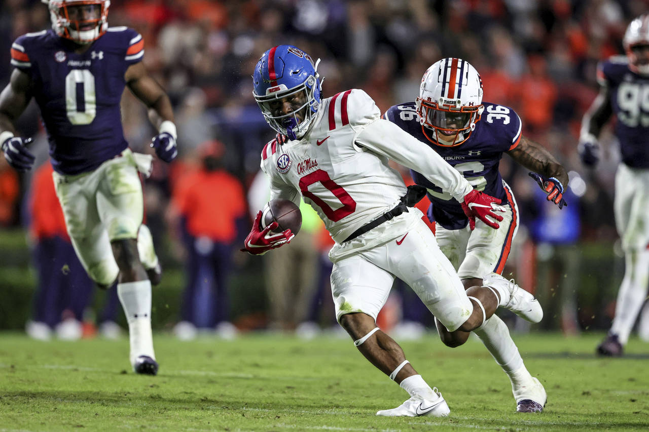 Mississippi wide receiver Jahcour Pearson (0) carries the ball as Auburn cornerback Jaylin Simpson ...