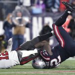 
              Tampa Bay Buccaneers quarterback Tom Brady (12) is taken down by New England Patriots nose tackle Davon Godchaux (92) during the second half of an NFL football game, Sunday, Oct. 3, 2021, in Foxborough, Mass. (AP Photo/Steven Senne)
            