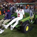 
              Mississippi quarterback Matt Corral (2) is taken off the field on a cart after an injury during the first half of the team's NCAA college football game against Auburn on Saturday, Oct. 30, 2021 in Auburn, Ala. (AP Photo/Butch Dill)
            