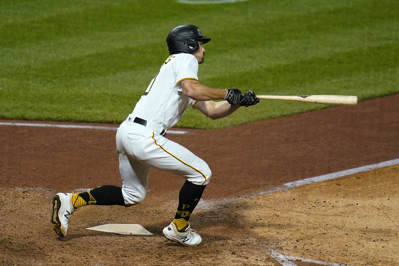 Pittsburgh Pirates' Bryan Reynolds triples to right field, off Cincinnati Reds relief pitcher Tony ...