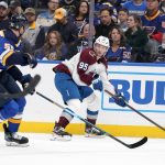 
              Colorado Avalanche's Andre Burakovsky (95) looks to pass as St. Louis Blues' Colton Parayko (55) defends during the first period of an NHL hockey game Thursday, Oct. 28, 2021, in St. Louis. (AP Photo/Jeff Roberson)
            