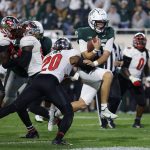 
              Michigan State quarterback Payton Thorne, right, runs for a touchdown against Western Kentucky's Kaleb Oliver (20) during the second quarter of an NCAA college football game, Saturday, Oct. 2, 2021, in East Lansing, Mich. (AP Photo/Al Goldis)
            