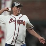 
              Former Atlanta Braves pitcher Greg Maddux throws out the ceremonial first pitch before Game 5 of baseball's World Series between the Houston Astros and the Atlanta Braves Sunday, Oct. 31, 2021, in Atlanta. (AP Photo/David J. Phillip)
            