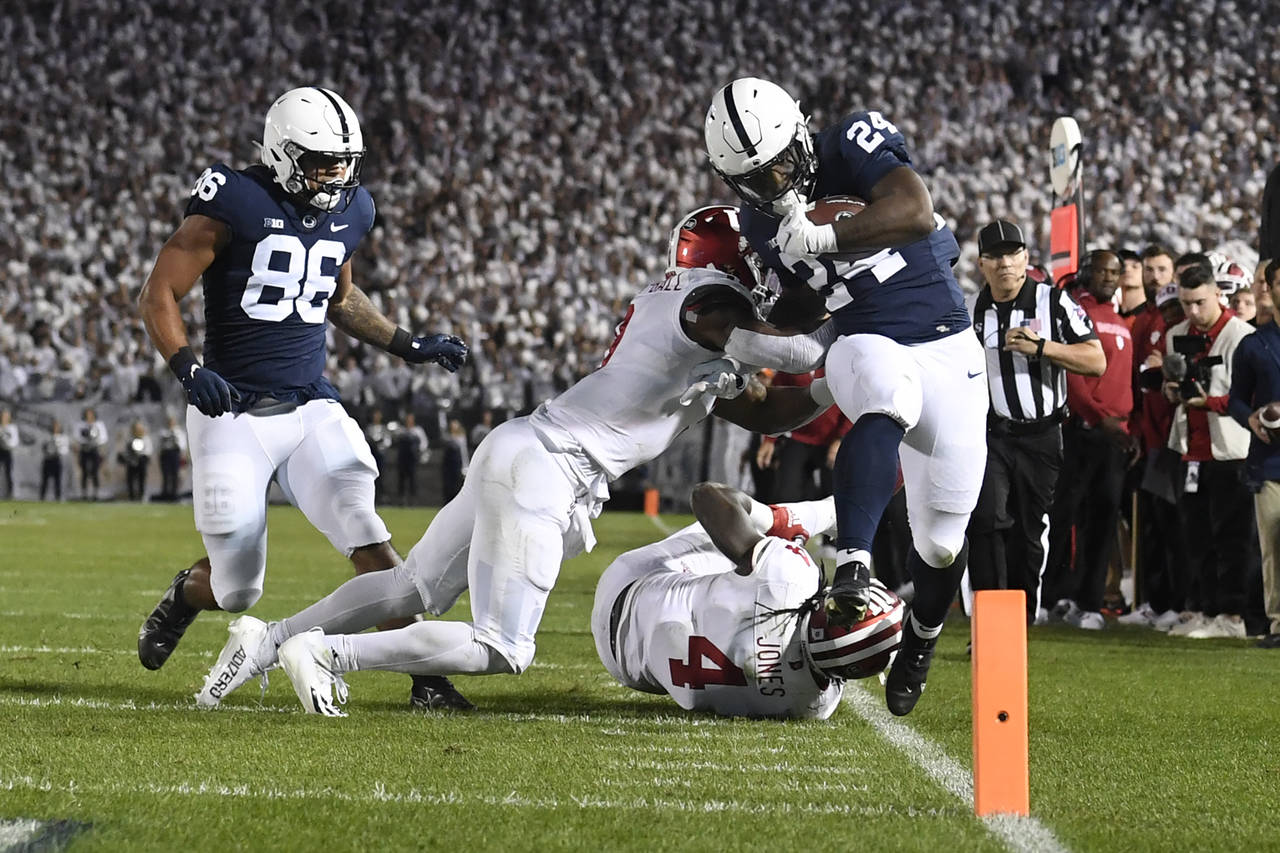 Penn State running back Keyvone Lee (24) is tackled by Indiana linebacker Cam Jones (4) in the firs...