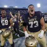 
              Navy players celebrate after defeating UCF 34-30 during an NCAA college football game, Saturday, Oct. 2, 2021, in Annapolis, Md. (AP Photo/Julio Cortez)
            