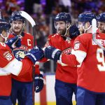 
              Florida Panthers defenseman Aaron Ekblad (5) celebrates with teammates after scoring a goal against the Arizona Coyotes during the second period of an NHL hockey game, Monday, Oct. 25, 2021, in Sunrise, Fla. (AP Photo/Michael Reaves)
            