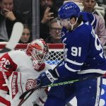 
              Toronto Maple Leafs forward John Tavares (91) tries to tip the puck past Detroit Red Wings goaltender Thomas Greiss (29) during first-period NHL hockey game action in Toronto, Saturday, Oct. 30, 2021. (Nathan Denette/The Canadian Press via AP)
            