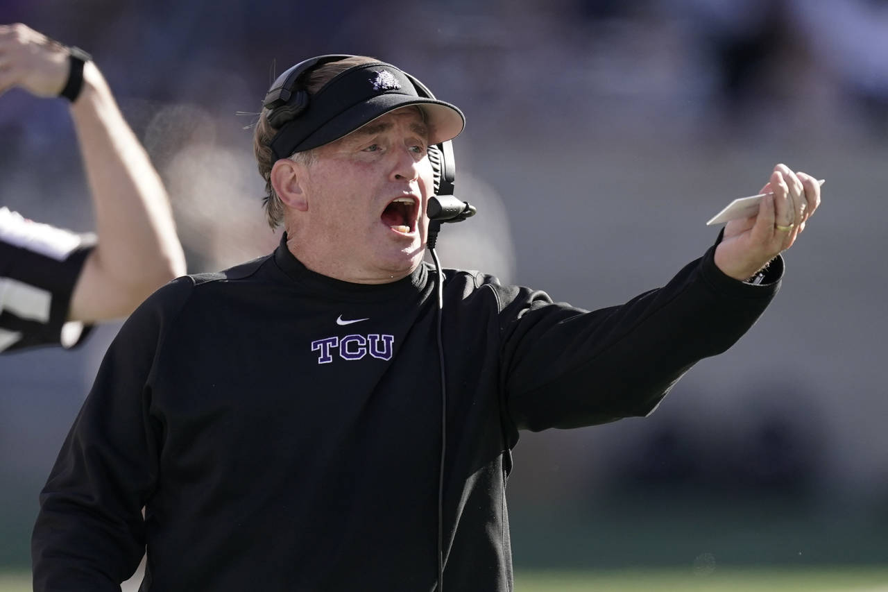 TCU head coach Gary Patterson talks to his players during the first half of an NCAA college footbal...