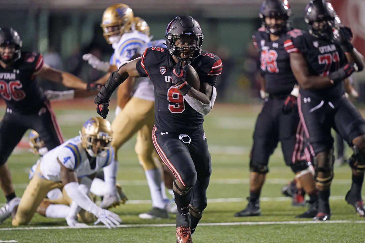 Utah running back Tavion Thomas (9) carries the ball for a touchdown in the second half during an N...