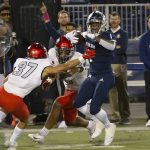 
              Nevada's Melquan Stovall (1) tries to get away from UNLV's Davone Walden Jr. (37) during the first half of an NCAA college football game in Reno, Nev., Friday, Oct. 29, 2021. (AP Photo/Tom R. Smedes)
            