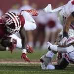 
              Indiana running back Davion Ervin-Poindexter (22) is tackled by Ohio State linebacker Teradja Mitchell, lower right in the first quarter of an NCAA college football game in Bloomington, Ind., Saturday, Oct. 23, 2021. (AP Photo/AJ Mast)
            