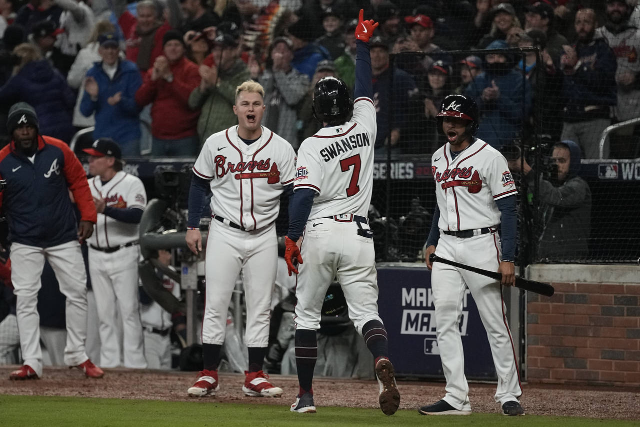 Atlanta Braves' Dansby Swanson celebrates his home run during the seventh inning in Game 4 of baseb...