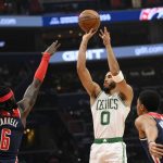 
              Boston Celtics forward Jayson Tatum (0) shoots against Washington Wizards center Montrezl Harrell (6) and guard Spencer Dinwiddie (26) during the first half of an NBA basketball game, Saturday, Oct. 30, 2021, in Washington. (AP Photo/Nick Wass)
            