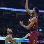 
              Cleveland Cavaliers' Evan Mobley, right, shoots over Charlotte Hornets' Miles Bridges in the first half of an NBA basketball game, Friday, Oct. 22, 2021, in Cleveland. (AP Photo/Tony Dejak)
            