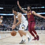
              Denver Nuggets guard Facundo Campazzo, front left, drives past Cleveland Cavaliers guard Ricky Rubio in the second half of an NBA basketball game Monday, Oct. 25, 2021, in Denver. (AP Photo/David Zalubowski)
            