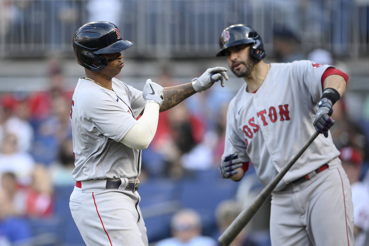Boston Red Sox' Rafael Devers, left, celebrates his home run with J.D. Martinez, right, during the ...