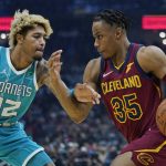 
              Cleveland Cavaliers' Isaac Okoro (35) drives past Charlotte Hornets' Kelly Oubre Jr. (12) in the first half of an NBA basketball game, Friday, Oct. 22, 2021, in Cleveland. (AP Photo/Tony Dejak)
            