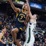 
              Indiana Pacers guard Malcolm Brogdon (7) shoots in front of Milwaukee Bucks guard Pat Connaughton (24) during the first half of an NBA basketball game in Indianapolis, Monday, Oct. 25, 2021. (AP Photo/Michael Conroy)
            