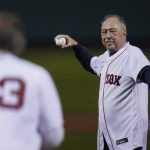 
              FILE - Former Boston Red Sox player Jerry Remy, wearing an oxygen tube, throws a ceremonial first pitch to former Red Sox pitcher Dennis Eckersley before an American League Wild Card baseball game against the New York Yankees at Fenway Park, Tuesday, Oct. 5, 2021, in Boston. Remy, a Boston Red Sox second baseman who went on to become a local icon as a television broadcaster, died of cancer on Saturday, Oct. 30, 2021. He was 68. (AP Photo/Charles Krupa, File)
            