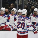 
              New York Rangers left wing Chris Kreider (20) is congratulated by the bench on his goal during the first period of an NHL hockey game against the Seattle Kraken, Sunday, Oct. 31, 2021, in Seattle. (AP Photo/Lindsey Wasson)
            
