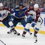 
              Colorado Avalanche's Jack Johnson (3) passes as teammate Darren Helm (43) and St. Louis Blues' David Perron (57) watch during the second period of an NHL hockey game Thursday, Oct. 28, 2021, in St. Louis. (AP Photo/Jeff Roberson)
            