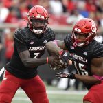 
              Louisville quarterback Malik Cunningham (3) hand the ball off to running back Jalen Mitchell (15) during the first half of an NCAA college football game in Louisville, Ky., Saturday, Oct. 23, 2021. (AP Photo/Timothy D. Easley)
            