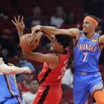 
              Houston Rockets center Christian Wood, center, has his shot blocked by Oklahoma City Thunder forward Darius Bazley (7) as guard Josh Giddey (3) looks on during the first half of an NBA basketball game Friday, Oct. 22, 2021, in Houston. (AP Photo/Michael Wyke)
            