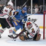 
              St. Louis Blues' Kyle Clifford (13) keeps is eye on a loose puck as Chicago Blackhawks goaltender Marc-Andre Fleury (29) and Erik Gustafsson (56) defend during the second period of an NHL hockey game Saturday, Oct. 30, 2021, in St. Louis. (AP Photo/Jeff Roberson)
            