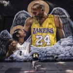 
              FILE - In this Jan. 26, 2021, file photo, a fan pays his respects to Kobe Bryant and his daughter, Gianna, in front of a mural in Los Angeles. According to court documents, Kobe Bryant's widow said she pleaded with the Los Angeles County sheriff to make sure no one takes photographs from the site of the 2020 helicopter crash that killed the basketball star and their daughter, and he reassured that the area had been secured. (AP Photo/Jae C. Hong, File)
            
