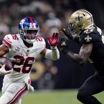 
              New York Giants running back Saquon Barkley (26) carries against New Orleans Saints strong safety Malcolm Jenkins (27) in the first half of an NFL football game in New Orleans, Sunday, Oct. 3, 2021. (AP Photo/Brett Duke)
            
