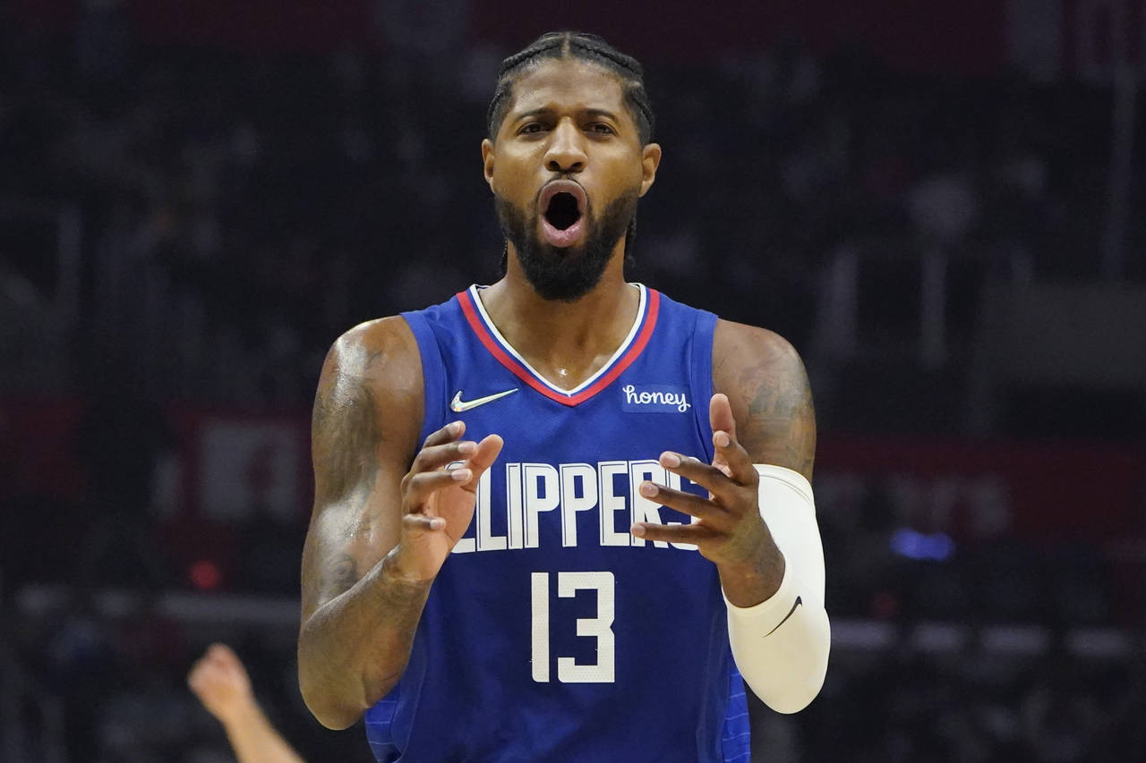 Los Angeles Clippers guard Paul George argues a call with a referee during the first half of an NBA...