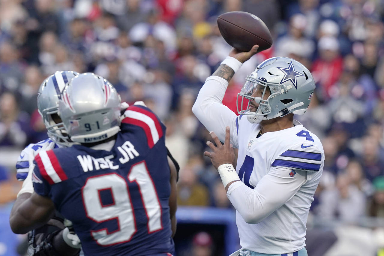 Dallas Cowboys quarterback Dak Prescott (4) throws a pass while pressured by New England Patriots d...
