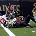 
              New York Giants wide receiver John Ross (12) loses the ball on a touchdown reception as he is tackled at the goal line yy New Orleans Saints cornerback Paulson Adebo (29) and free safety Marcus Williams in the first half of an NFL football game in New Orleans, Sunday, Oct. 3, 2021. (AP Photo/Derick Hingle)
            