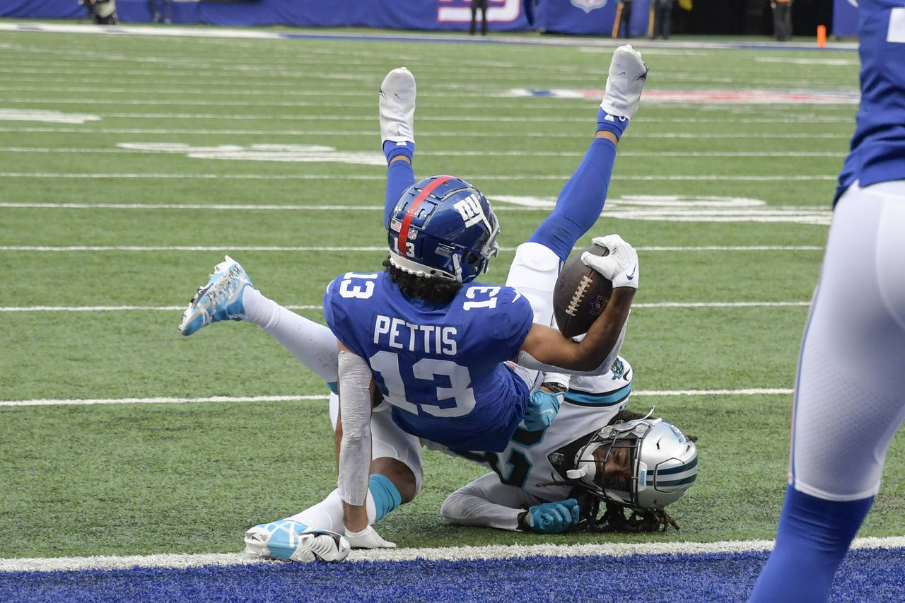 Carolina Panthers' Stantley Thomas-Oliver (23) tackles New York Giants' Dante Pettis (13) at the go...