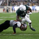 
              Michigan State's Kenneth Walker III, top, dives over Western Kentucky's Miguel Edwards for a touchdown during the first quarter of an NCAA college football game, Saturday, Oct. 2, 2021, in East Lansing, Mich. (AP Photo/Al Goldis)
            