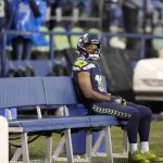 
              Seattle Seahawks' Tyler Lockett sits on the bench after his team lost to the New Orleans Saints in an NFL football game, Monday, Oct. 25, 2021, in Seattle. (AP Photo/Ted S. Warren)
            