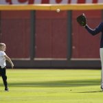 
              Atlanta Braves' Freddie Freeman works out with his son, Charlie, ahead of the NLCS playoff baseball game, Thursday, Oct. 14, 2021, in Atlanta. (AP Photo/Brynn Anderson)
            