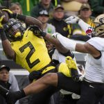 
              Oregon wide receiver Devon Williams (2) catches a pass over Colorado cornerback Christian Gonzalez (3) during the second quarter of an NCAA college football game Saturday, Oct. 30, 2021, in Eugene, Ore. (AP Photo/Andy Nelson)
            