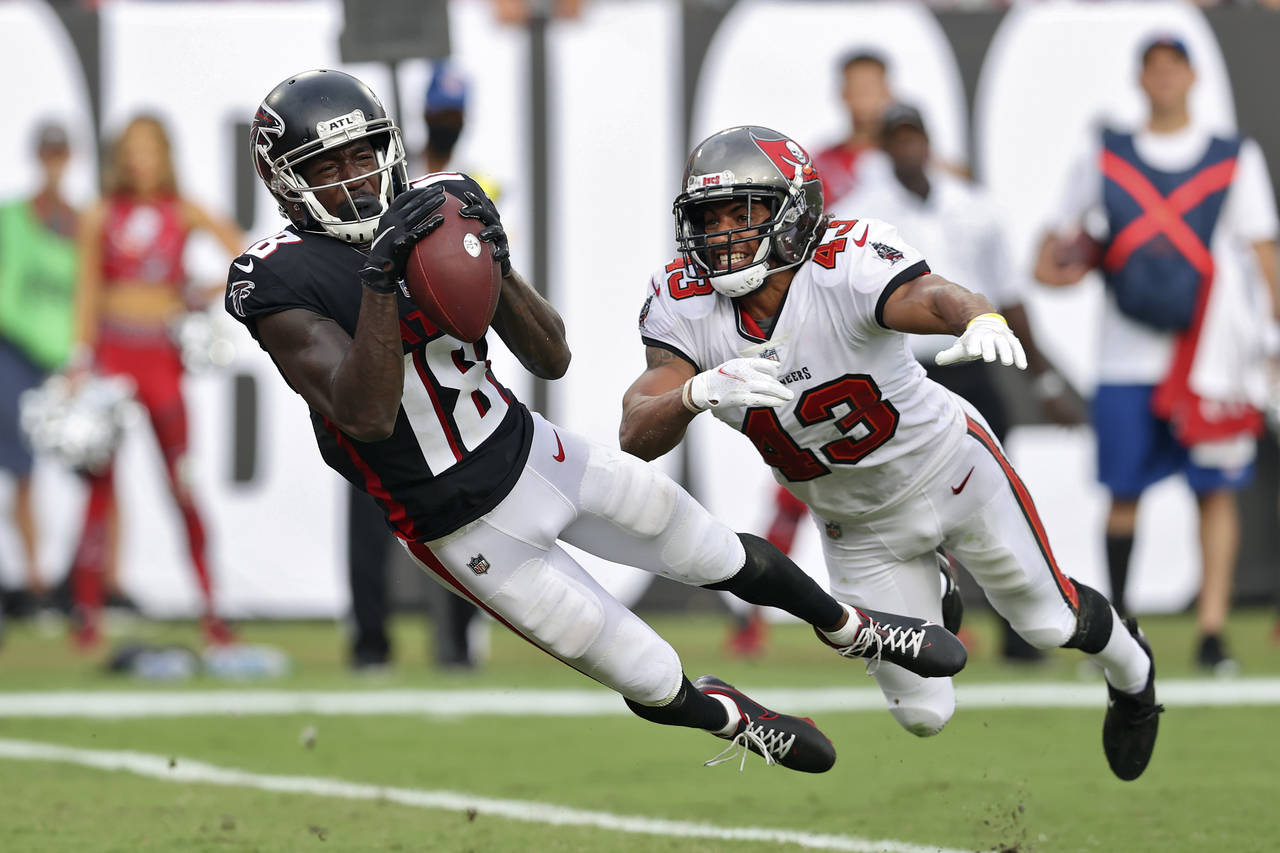 FILE - Atlanta Falcons wide receiver Calvin Ridley (18) makes a diving touchdown reception in front...