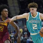 
              Charlotte Hornets' LaMelo Ball, right, drives against Cleveland Cavaliers' Collin Sexton during the second half of an NBA basketball game Friday, Oct. 22, 2021, in Cleveland. Charlotte won 123-112. (AP Photo/Tony Dejak)
            