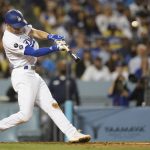 
              Los Angeles Dodgers' Trea Turner hits a grand slam home run during the fifth inning of a baseball game against the Milwaukee Brewers Friday, Sept. 1, 2021, in Los Angeles. Austin Barnes, Albert Pujols, and Mookie Betts also scored. (AP Photo/Ashley Landis)
            