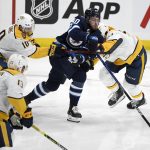 
              Winnipeg Jets' Pierre-Luc Dubois (80) gets past Nashville Predators' Colton Sissons (10) and Dante Fabbro (57) during the second period of NHL hockey game action in Winnipeg, Manitoba, Saturday, Oct. 23, 2021. (Fred Greenslade/The Canadian Press via AP)
            