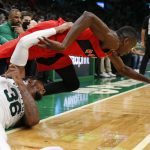 
              Boston Celtics' Marcus Smart (36) and Toronto Raptors' Chris Boucher battle for the ball during the second half of an NBA basketball game, Friday, Oct. 22, 2021, in Boston. (AP Photo/Michael Dwyer)
            