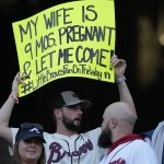 
              A Atlanta Braves fan holds up a sign during batting practice before Game 5 of baseball's World Series between the Houston Astros and the Atlanta Braves Sunday, Oct. 31, 2021, in Atlanta. (AP Photo/Brynn Anderson)
            