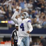 
              Dallas Cowboys quarterback Dak Prescott (4) celebrates after throwing a touchdown pass to tight end Blake Jarwin in the first half of a NFL football game against the Carolina Panthers in Arlington, Texas, Sunday, Oct. 3, 2021. (AP Photo/Ron Jenkins)
            